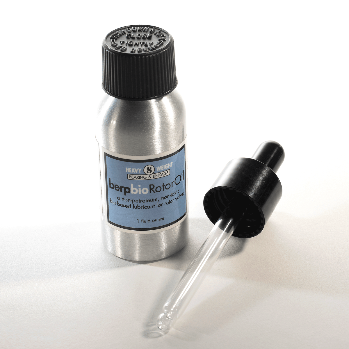Metal bottle with dropper labeled berp oil Rotor Oil on a white background